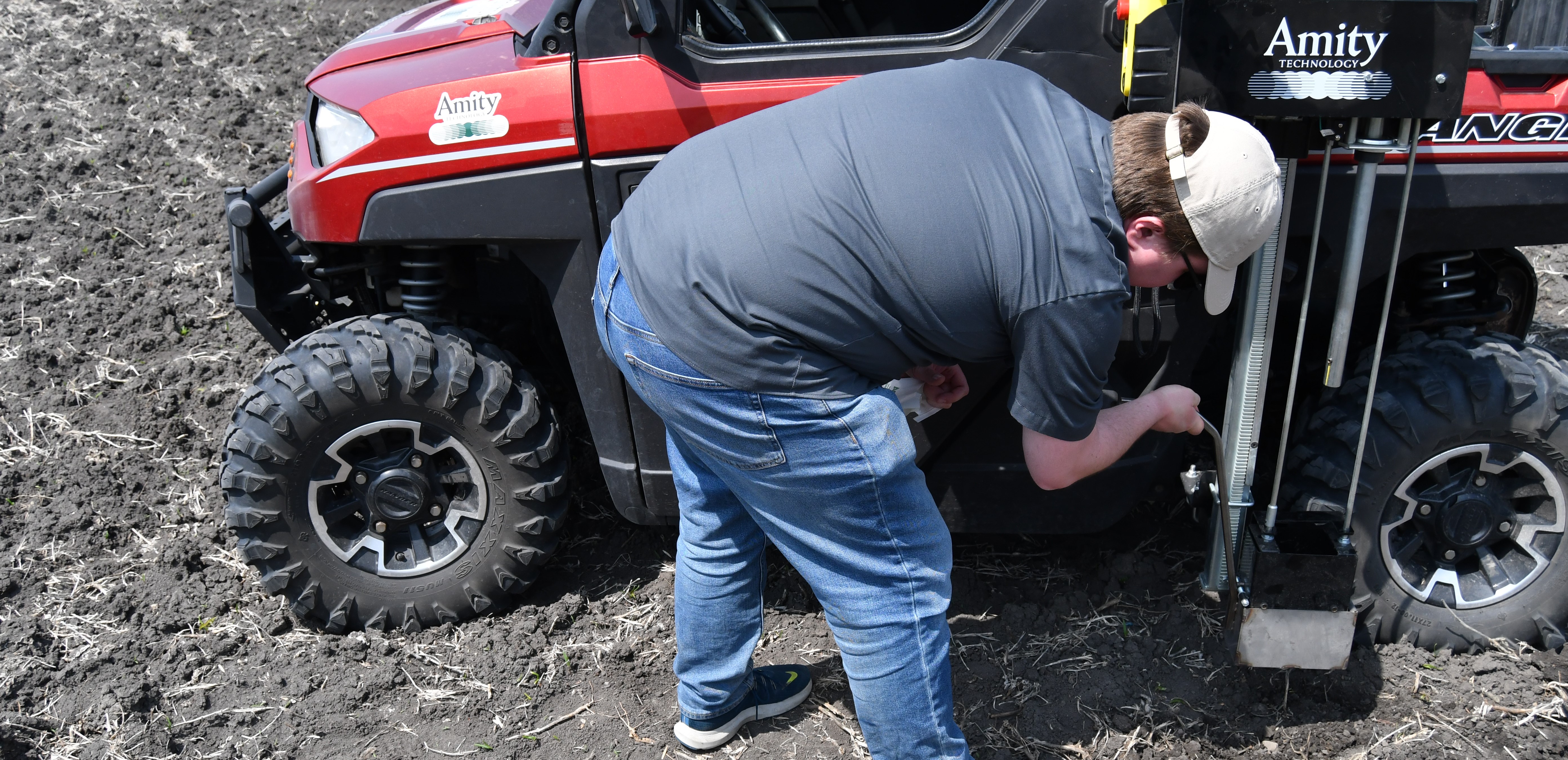 Man utilizing a UTV mounted Amity Technology 3000 Series Soil Sampler A man utilizing an Amity Technology Soil Sampler mounted on a Utility Task Vehicle.
